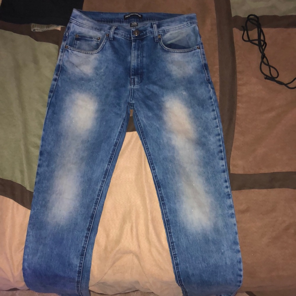Denim blue jeans with fades of white on pants leg